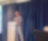 A person standing in front of a podium speaking on a microphone