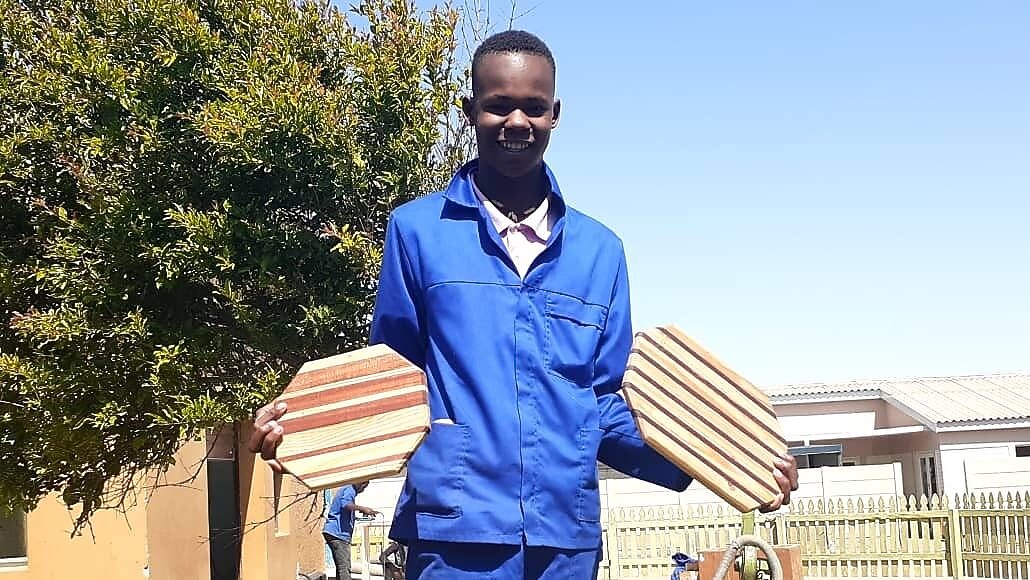 A person holding two wooden objects