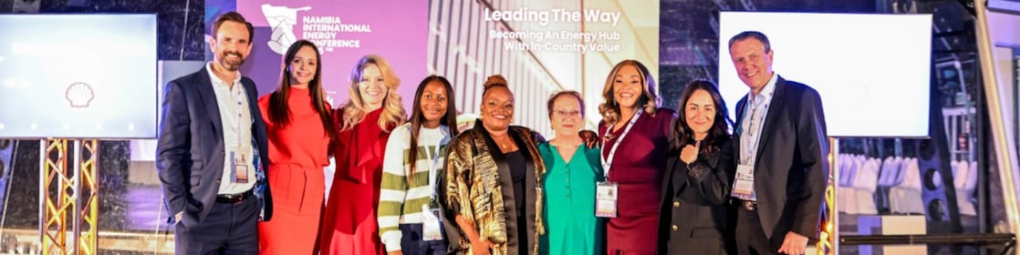 Shell delegates and event organiser on stage at Namibia International Energy Conference 2025, with event theme 'Leading The Way: Becoming An Energy Hub In The Southern Africa Region' and RICHAFRICA Consultancy banner visible.