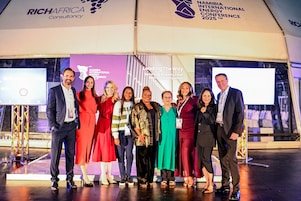 Shell delegates and event organiser on stage at Namibia International Energy Conference 2025, with event theme 'Leading The Way: Becoming An Energy Hub In The Southern Africa Region' and RICHAFRICA Consultancy banner visible.