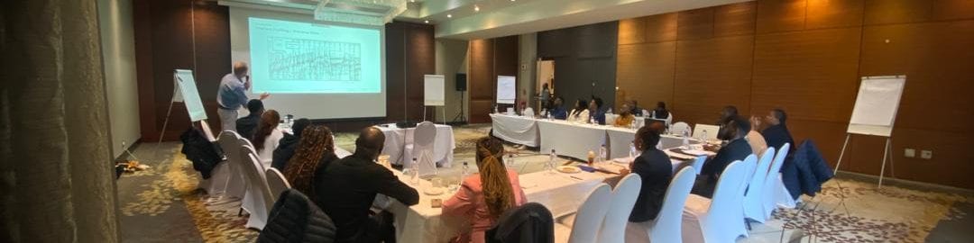 A group of people at an event standing on a flight of stairs in a hotel