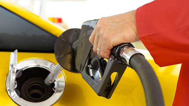 Person filling fuel at fuel station