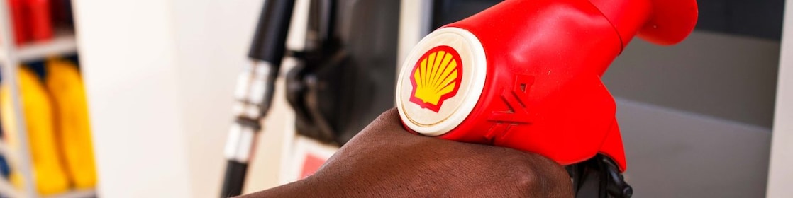 Service attendant holding a fuel nozzle